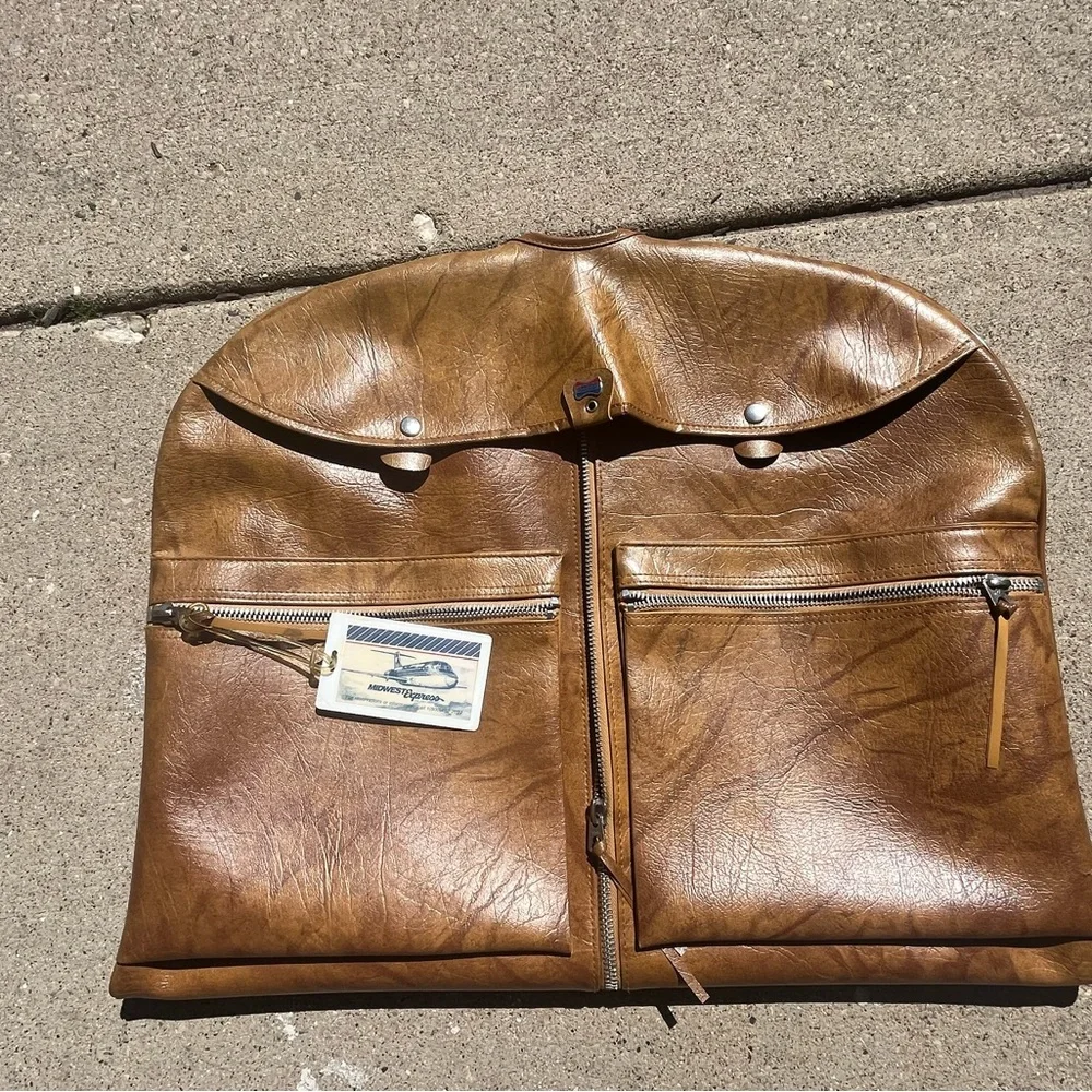 Vintage leather carry on for hanging clothes.